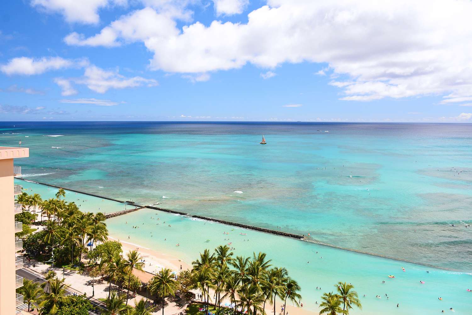 Sailboat Off The Shore Of Waikiki Beach In Honolulu