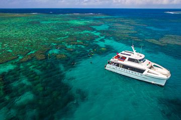 A boat and snorkelers in the Great Barrier Reef