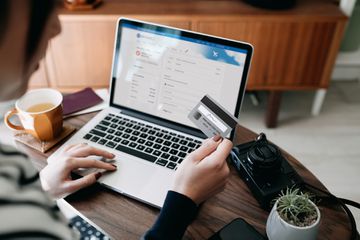 A woman buying for flight tickets on airline website on her laptop 