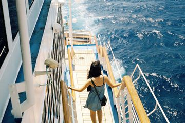 A woman walking down steps on the deck of a cruise ship