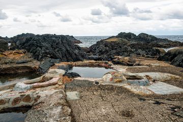 Hot springs of 46.7 degrees at the granite rocky beach of Yakushima island.