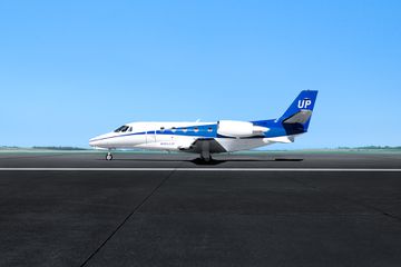 A Wheels Up private plane on a tarmac